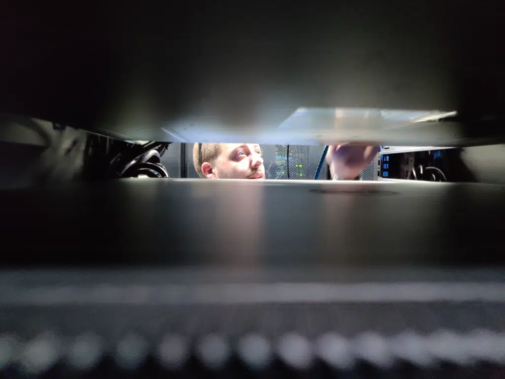 A Boca Raton IT provider works on a server rack at a South Florida data center.