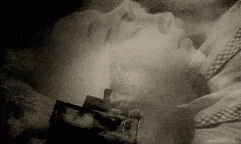 A woman sleeps as an image of a house being picked up by a tornado overlays her head.