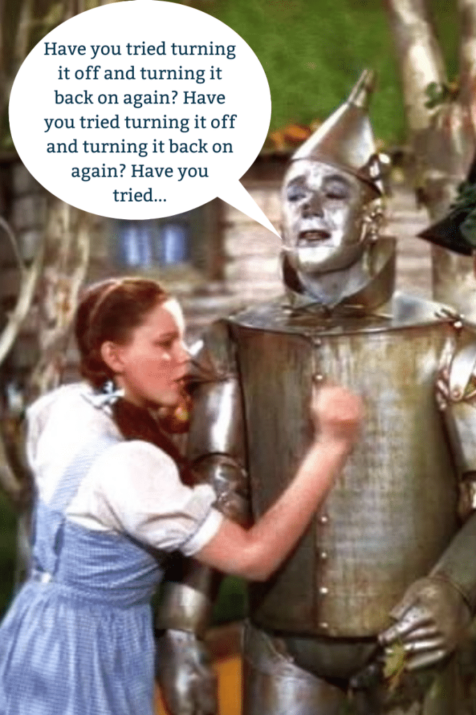 The Tin Man from Wizard of Oz as a South Florida IT service technician. He is pictured with a speech bubble saying "Have you tried turning it off and back on again?"